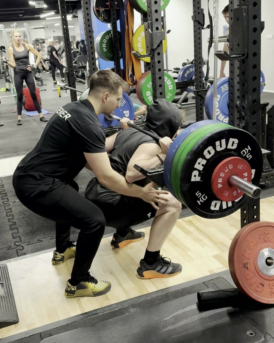 Personal training in Gdańsk: spotting a barbell squat
